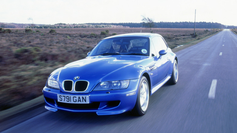 The BMW Z3 M Coupe in blue driving, front 3/4 view