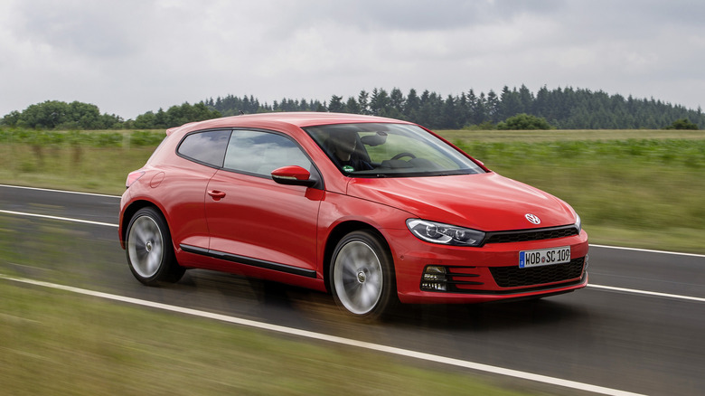 The Mk3 Volkswagen Scirocco in red driving, front 3/4 view