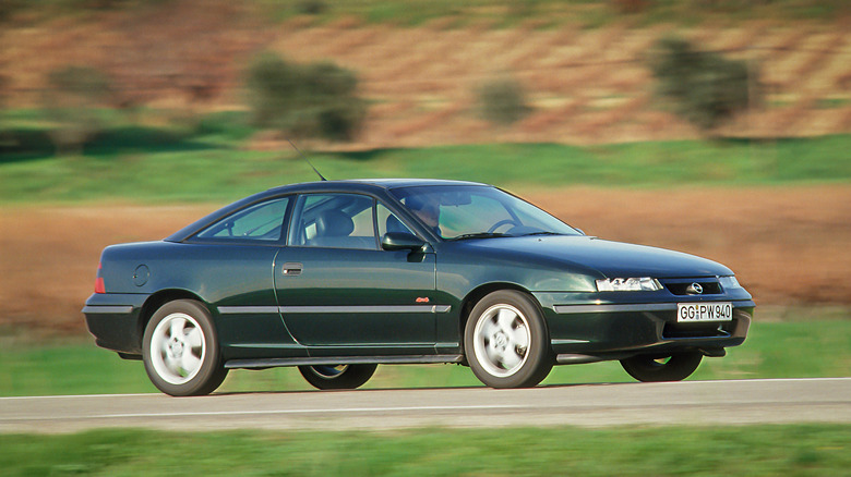 The Opel Calibra in green on the move, front 3/4 view