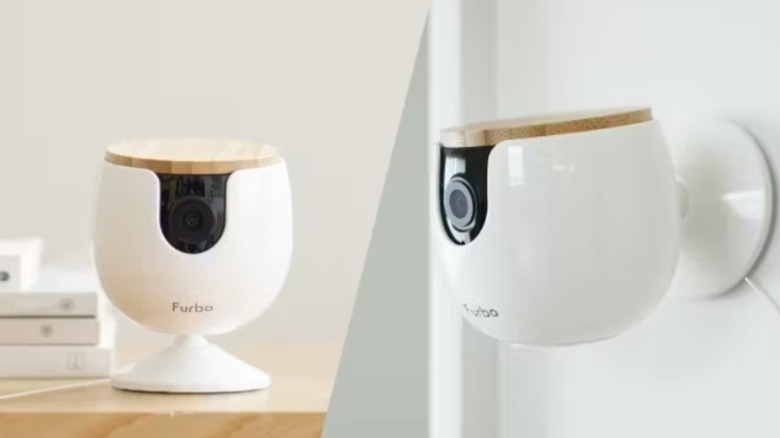 Small white camera device on a desk and mounted on a wall