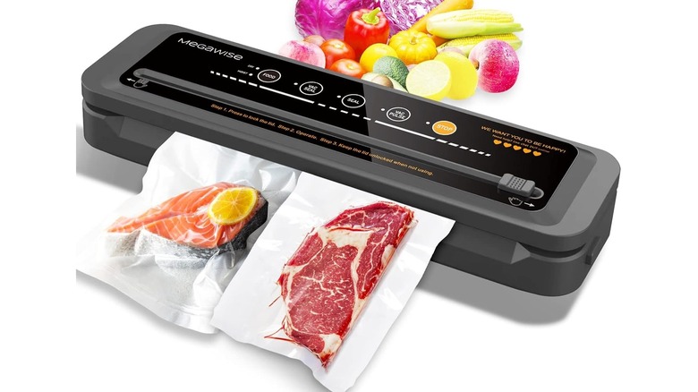 Black rectangular device vacuum sealing two bags of meat