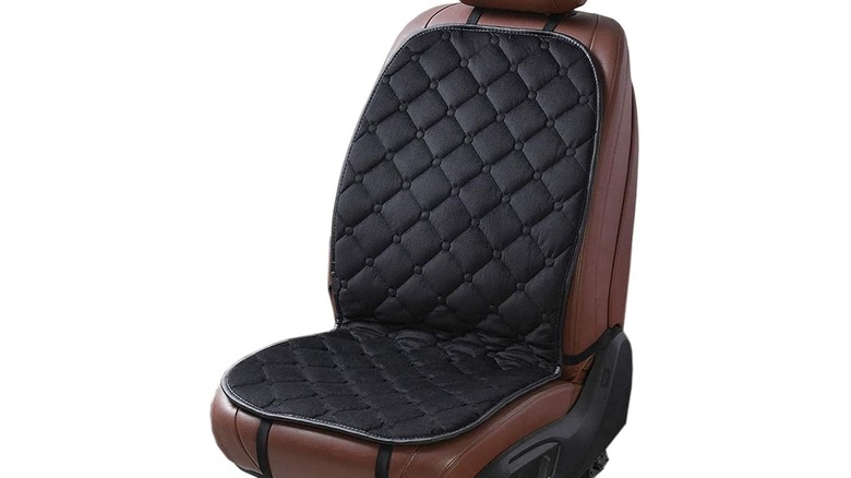 Black cushion on top of a car seat