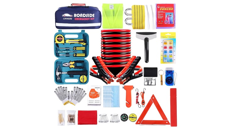 Collection of emergency tools including a triangular reflective sign, jumper cables, and toolbox