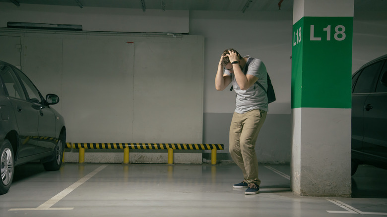 A frustrated man in a parking lot 