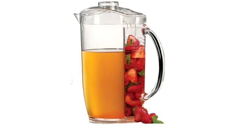 Pitcher filled with tea-like beverage and fruit