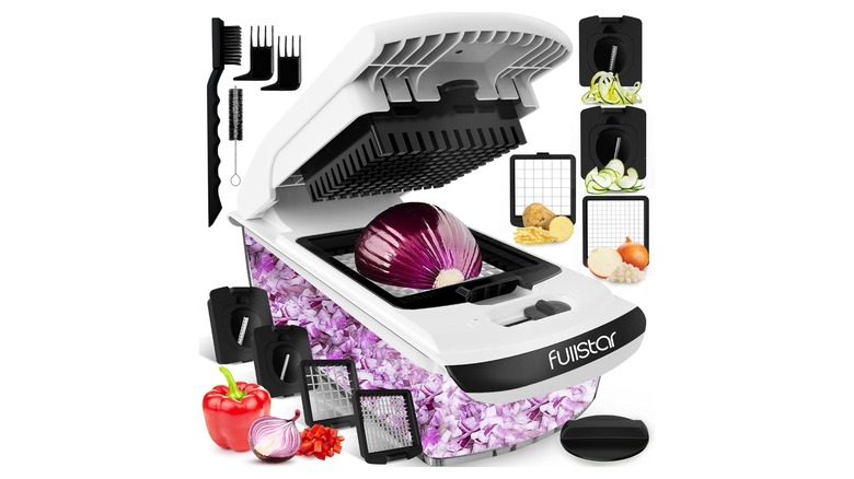 Food chopping device containing red onion pieces and a variety of attachments