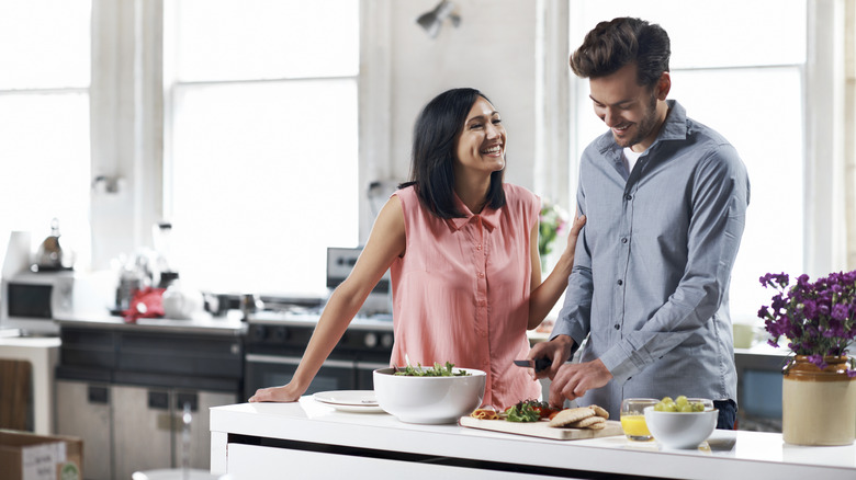 Man and woman in kitchen preparing a meal