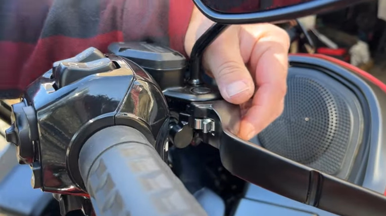 A close view of a motorcycle's brake lever