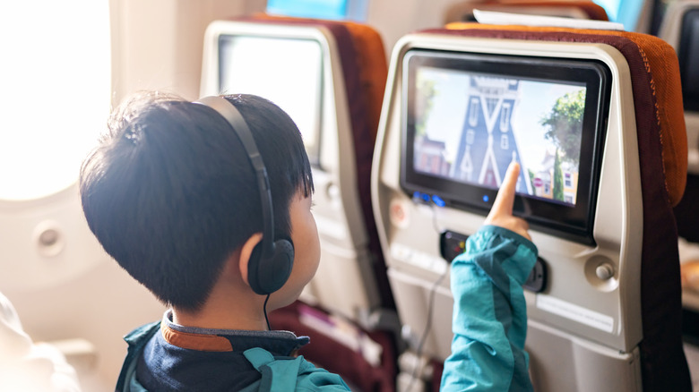 Child using in-flight entertainment system