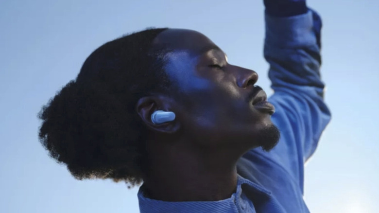 A man wearing Bose QuietComfort Ultra earbuds.