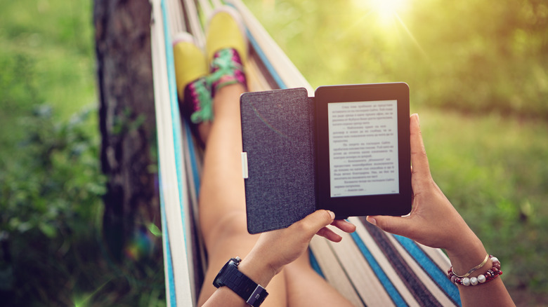 Reading an e-reader while swinging in a hammock.