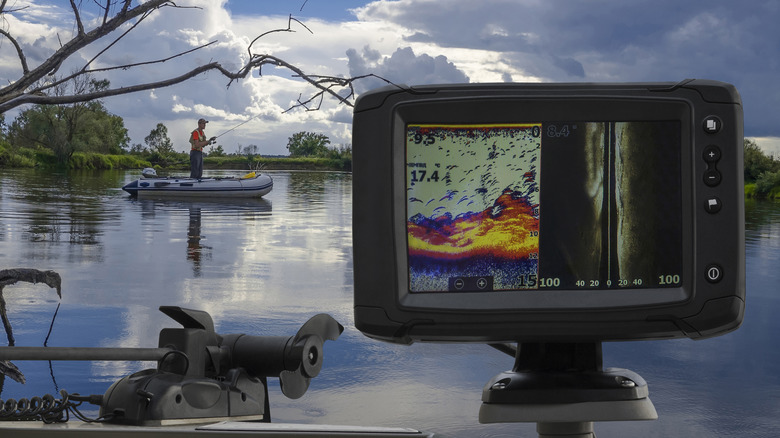 A fishfinder scanning the depths while an angler casts from his boat.