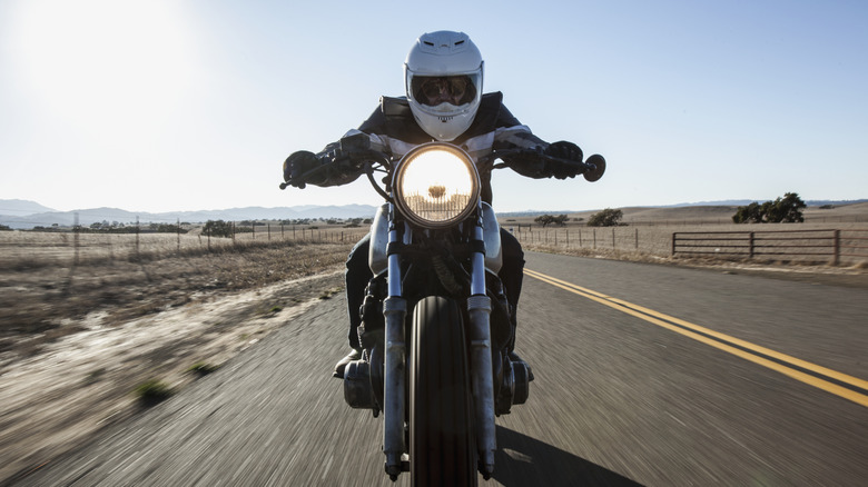 Man on motorcycle with white helmet