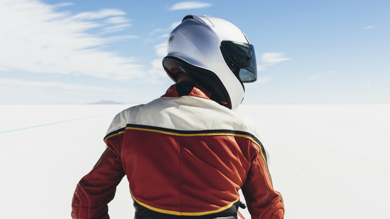 Motorcyclist wearing white full-face helmet