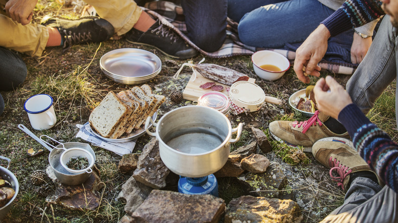 campers eating food outdoors