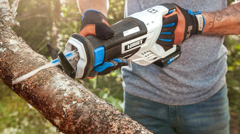 Man cutting branch with Hart saw