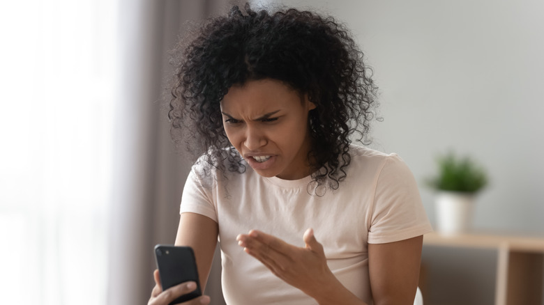 Woman swearing at phone