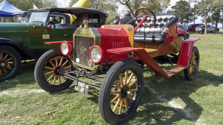 Old red 1915 Ford Model T open runabout roadster on the lawn