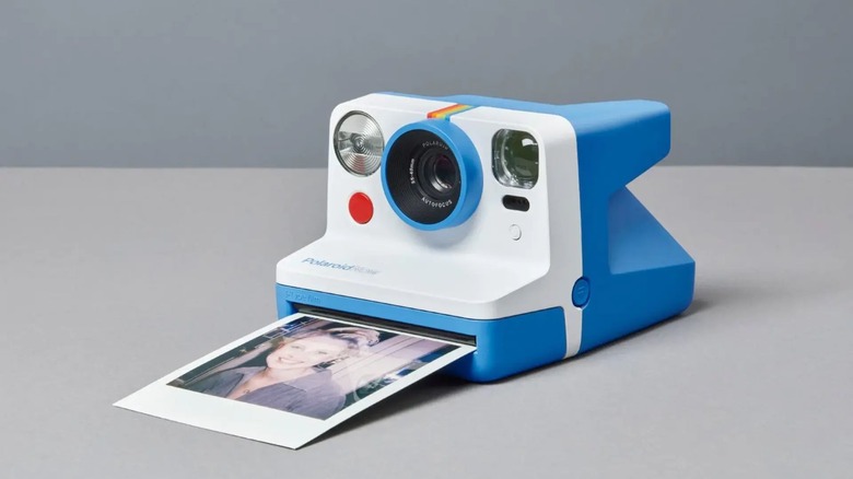 Polaroid camera printing photo