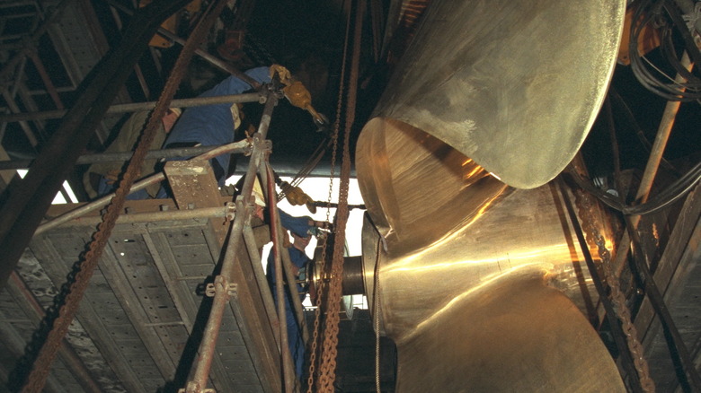 Man working on aircraft carrier propeller