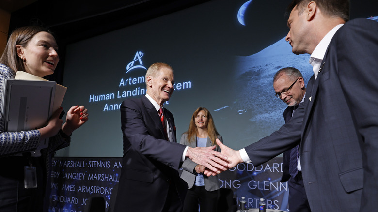 Individuals shaking hands at Artemis Accords