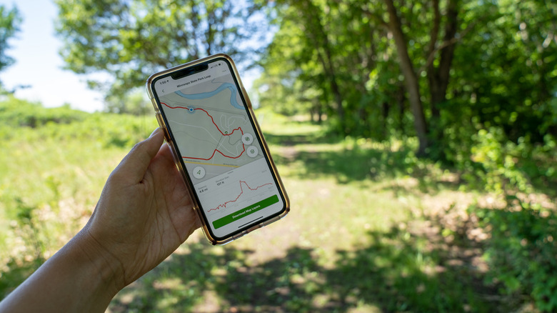 Someone using AllTrails on a hiking trail