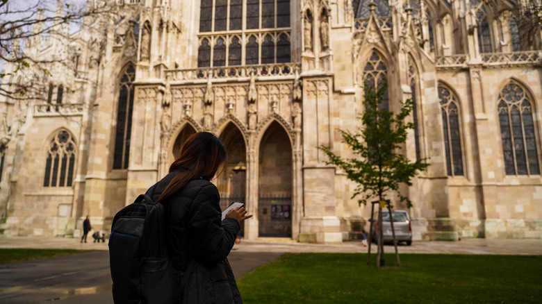 Woman infront of a monument using her iPhone