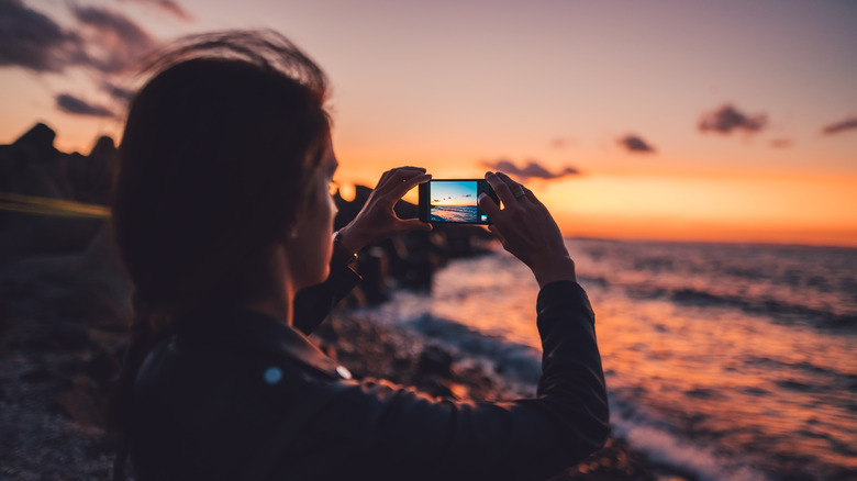 Woman taking a photo with her iPhone