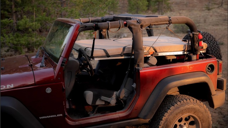 Maroon jeep with oryx platform bed