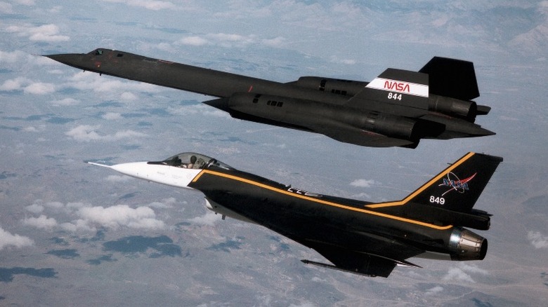 SR-71 Blackbird flys next to another aircraft