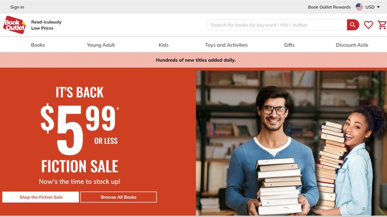 Book Outlet home page promoting a fiction sale and two customers holding stacks of books