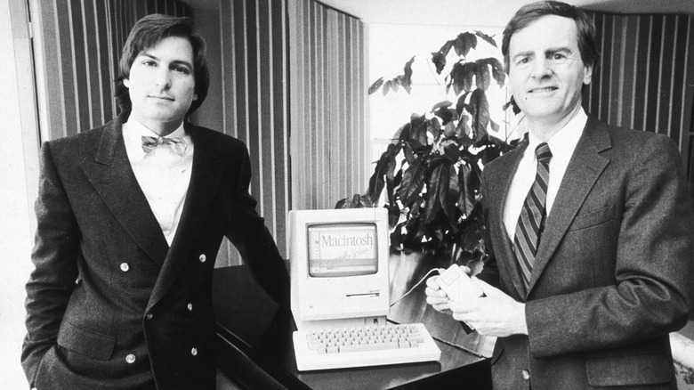 Steve Jobs and John Sculley posing with a Macintosh