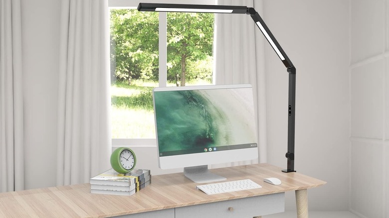 LED desk lamp on a desk with a computer monitor.