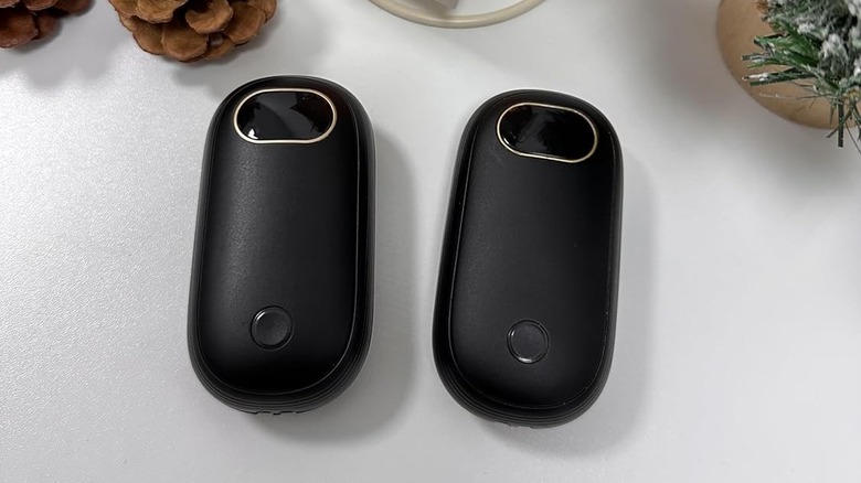 Rechargeable hand warmers on a white desk.