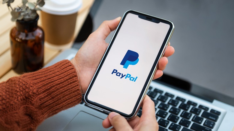 PayPal mobile app with PC in background