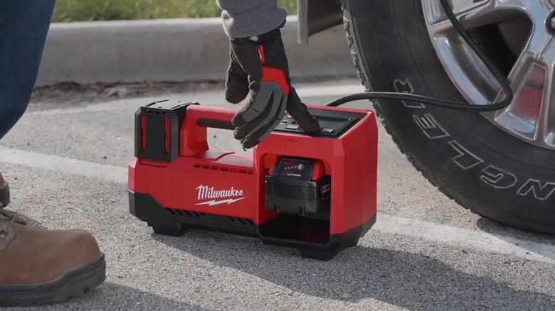 Tire inflator attached to car tire