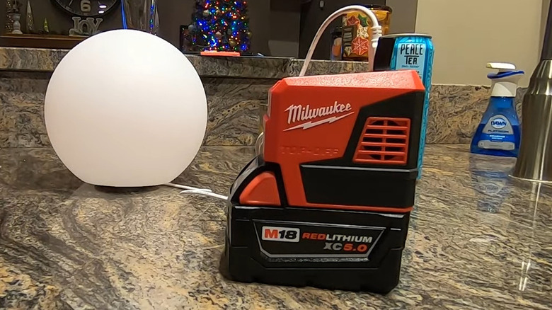 Milwaukee Top Off Power Supply with battery, plugged into light ball