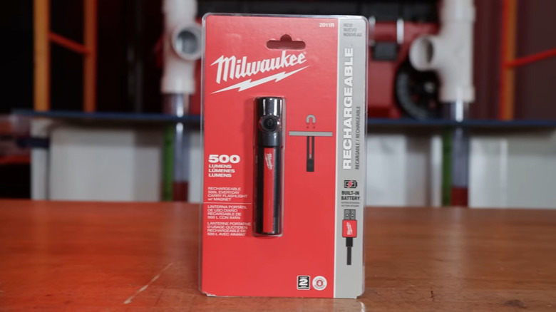 Milwaukee flashlight in package on work bench