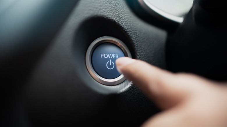 Finger pressing car's engine button