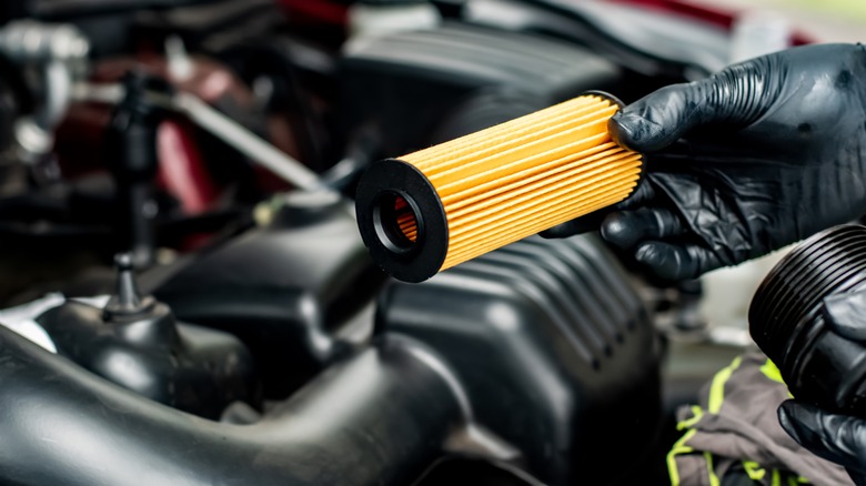 Person changing car's oil filter