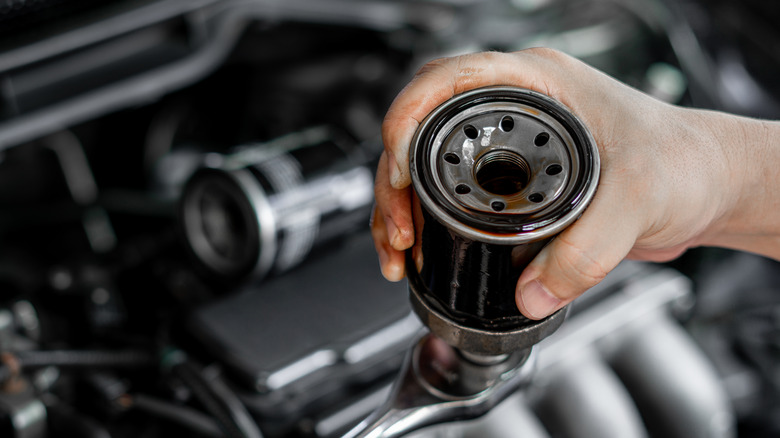 Man holding oil filter