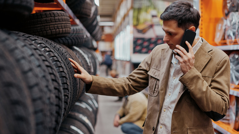 Man looking at new tires