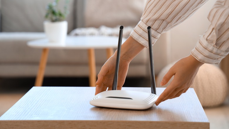 Woman setting up a Wi-Fi router