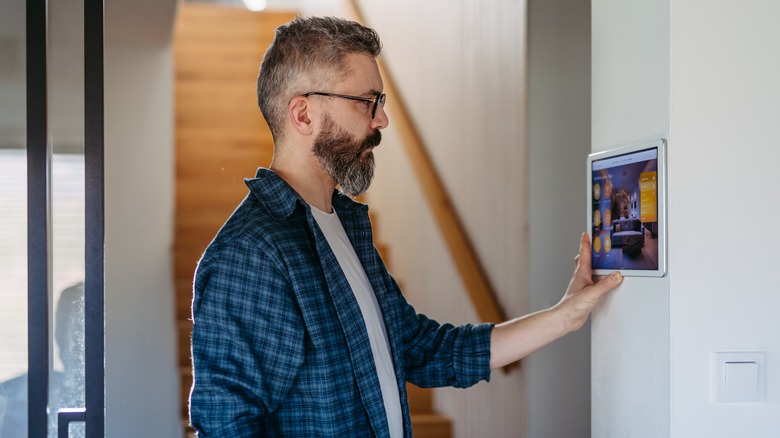 Man adjusting smart home system