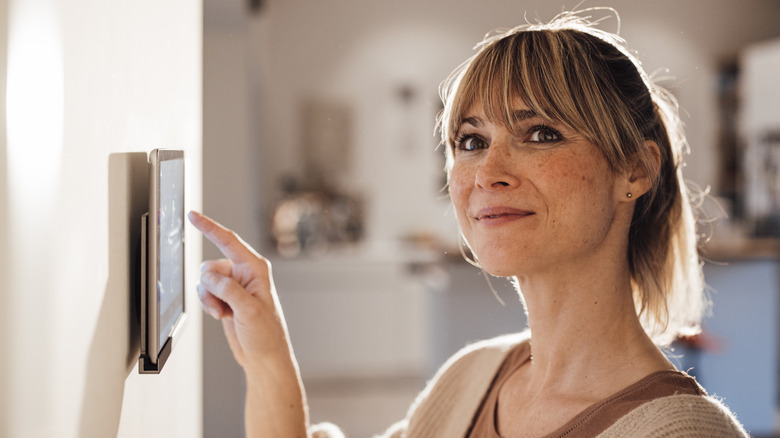 Woman altering settings on digital pad