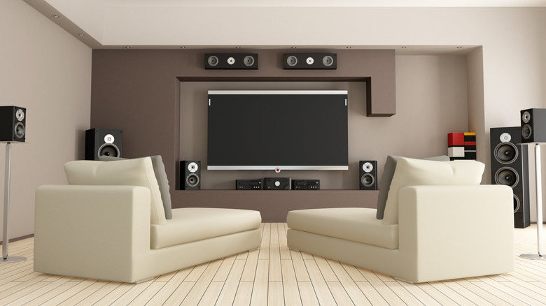 A home theater setup being controlled by a remote in the foreground