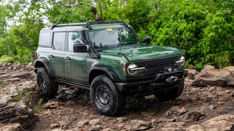 The Ford Bronco Everglades driving across a rocky trail, front 3/4 view