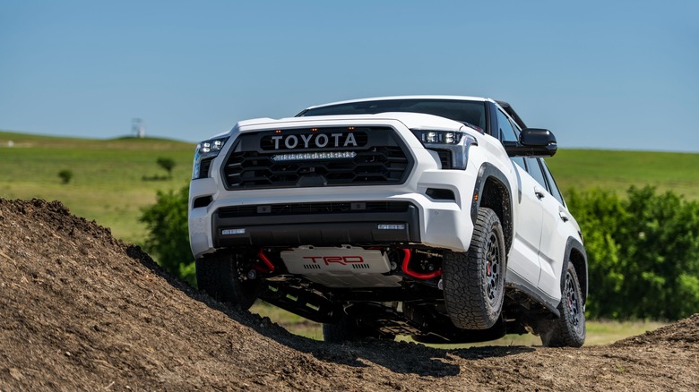 The Toyota Sequoia TRD Pro off-roading with a wheel in the air