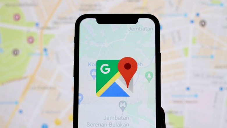 The Google Maps logo on a smartphone.