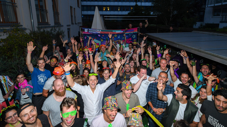 Backpackers partying in a hostel.